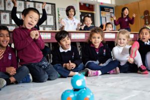Stratford School kindergarteners celebrate their coding skills with their Dash and Dot robot